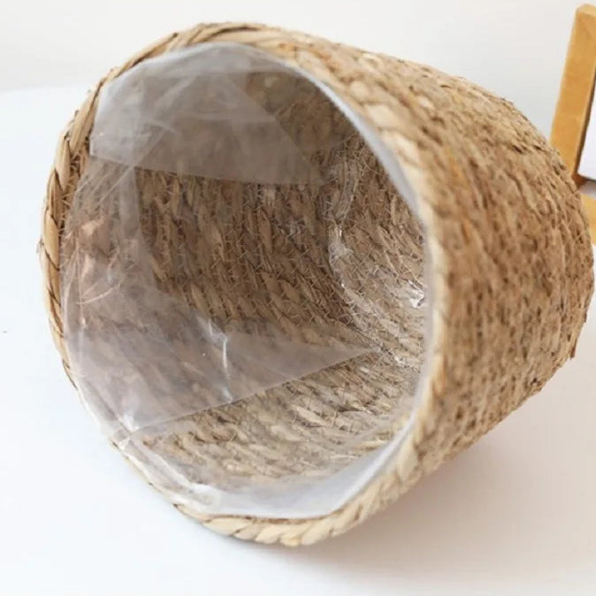 Woven basket with a clear plastic cover on a white background
