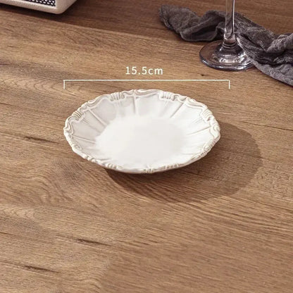 White decorative plate on a wooden surface with measurement