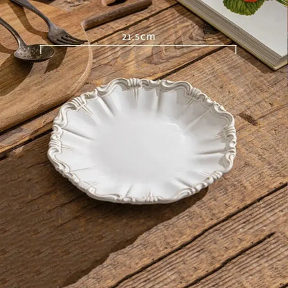 Decorative white ceramic plate on a wooden surface