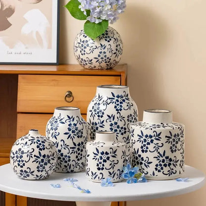 Set of ceramic vases with blue floral patterns on a table