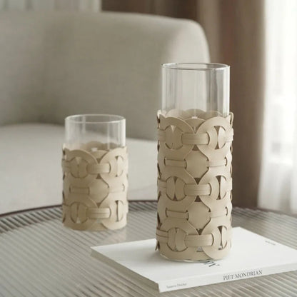 Two decorative vases with intricate patterns on a table.