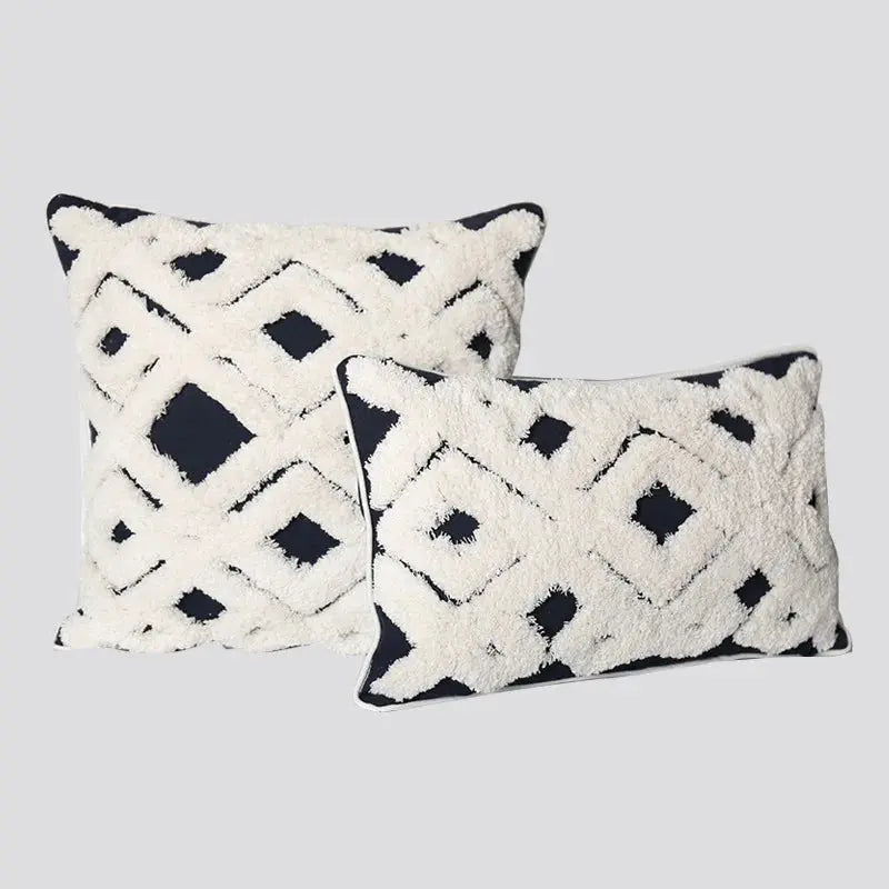 Two decorative pillows with geometric patterns on a light gray background