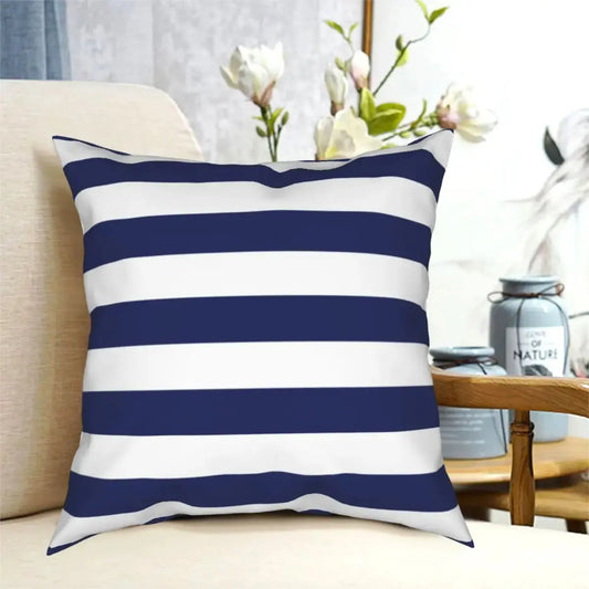 Navy and white striped pillow on a beige couch