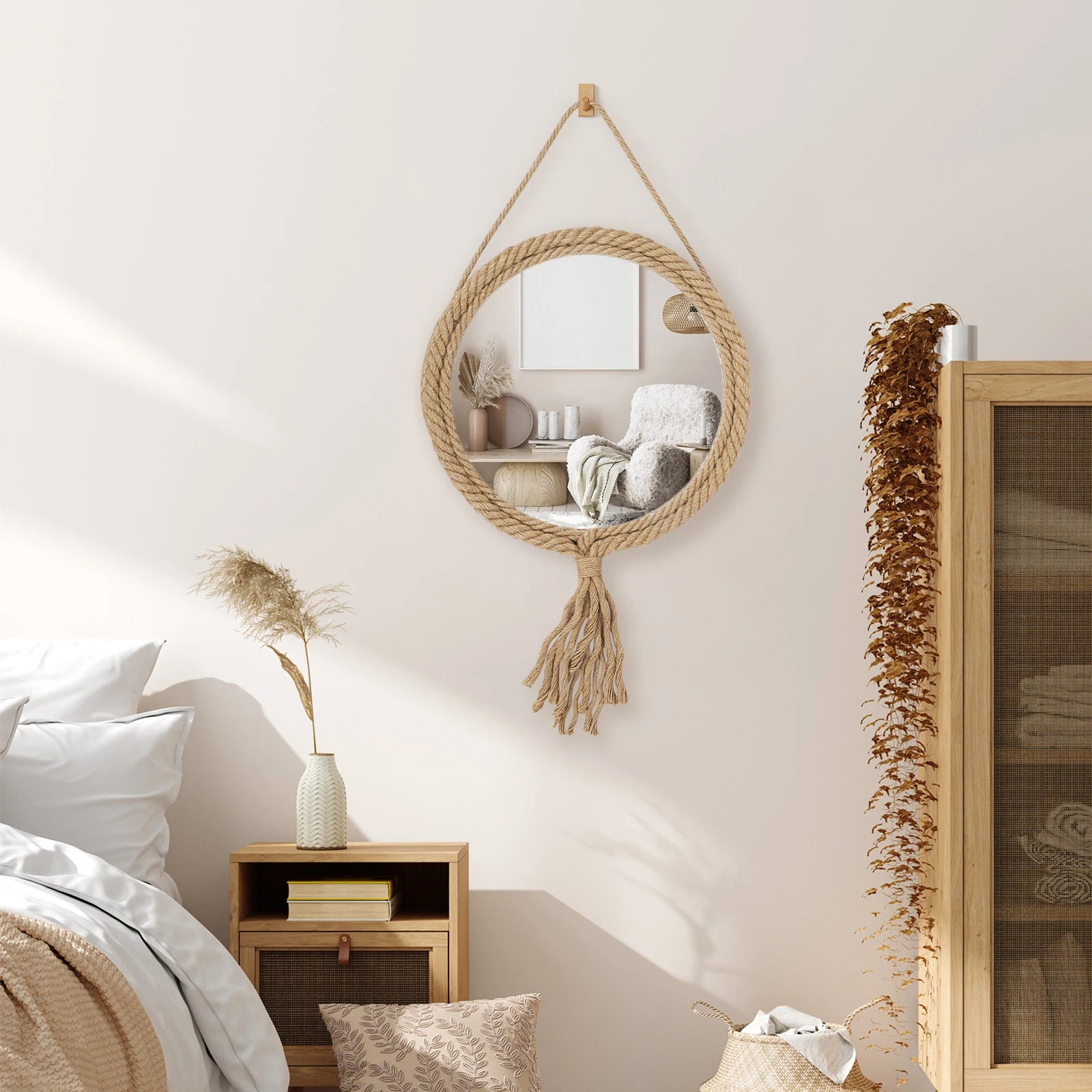 Hanging round mirror with tassels in a bedroom setting