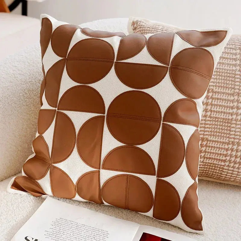 Decorative pillow with brown circular pattern on a couch