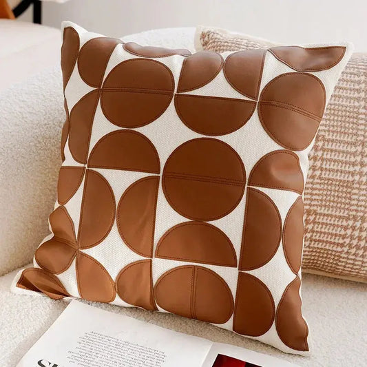 Decorative pillow with brown circular pattern on a couch