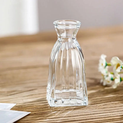 Clear glass carafe on a wooden surface with a blurred background