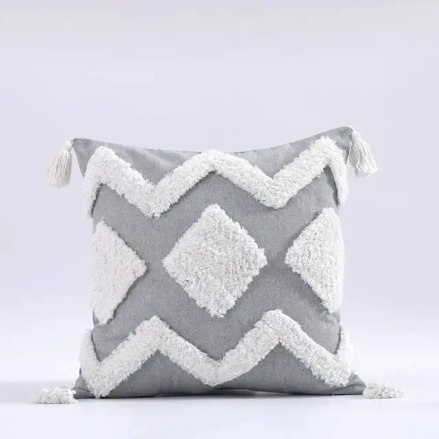 Gray pillow with white zigzag pattern on a light gray background