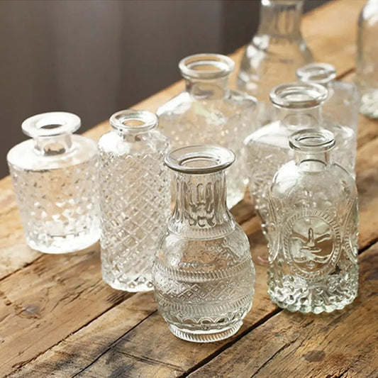 Set of clear glass vases on a wooden surface