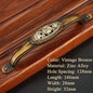 Decorative brass handle on a wooden surface with product details.