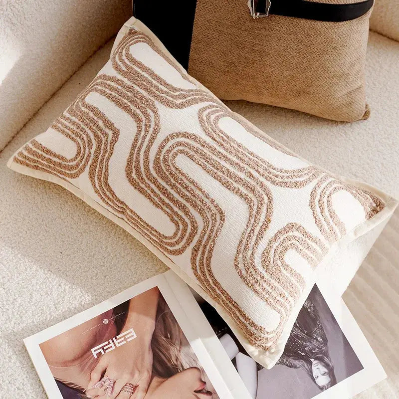Decorative pillow with wavy pattern on a couch next to a magazine