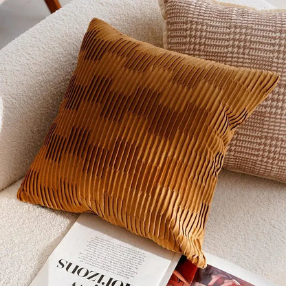 Brown textured pillow on a beige sofa with a magazine underneath