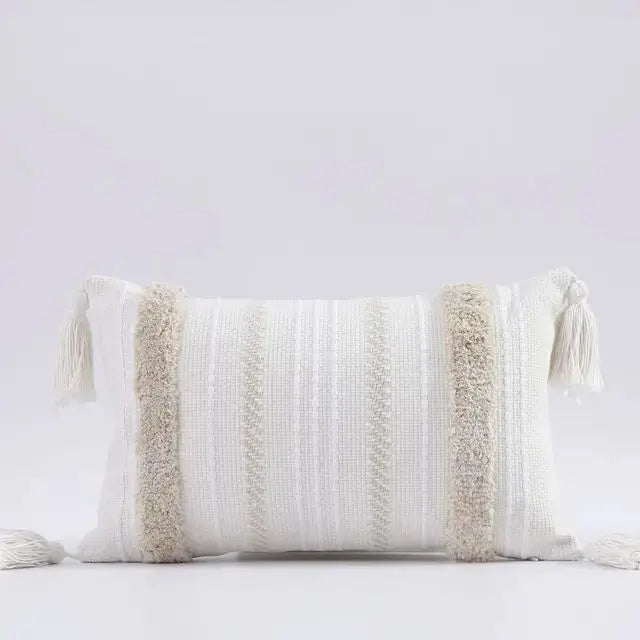 Decorative pillow with tassels on a light gray background