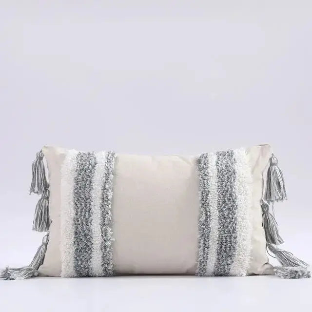 Decorative pillow with tassels on a light gray background