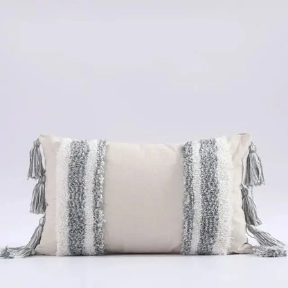 Decorative pillow with tassels on a light gray background