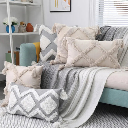 Decorative pillows and blanket on a sofa in a living room setting