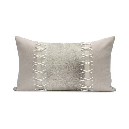 Gray pillow with white lace detailing on a white background