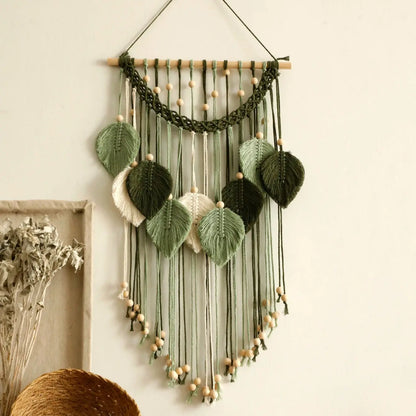 Decorative wall hanging with green leaves and string