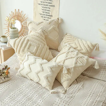 Decorative pillows on a bed with a neutral color scheme