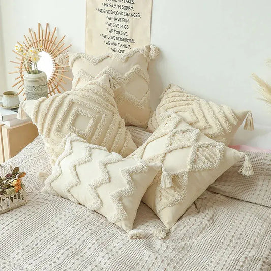 Decorative pillows on a bed with a neutral color scheme