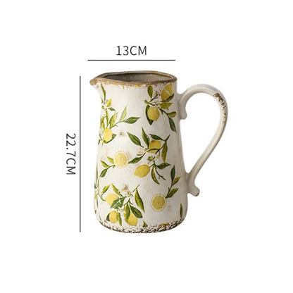 Ceramic pitcher with lemon pattern and measurements on a white background