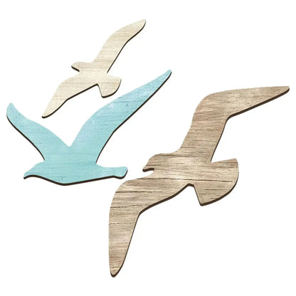Three wooden bird shapes in different colors on a white 