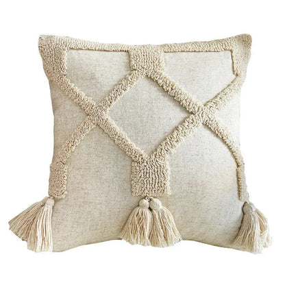 Decorative pillow with textured pattern and tassels on a white background
