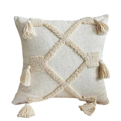Decorative pillow with geometric pattern and tassels on a white background