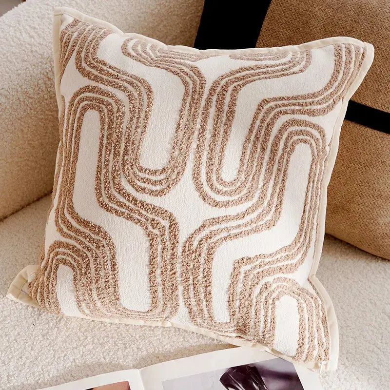 Decorative pillow with wavy pattern on a beige sofa