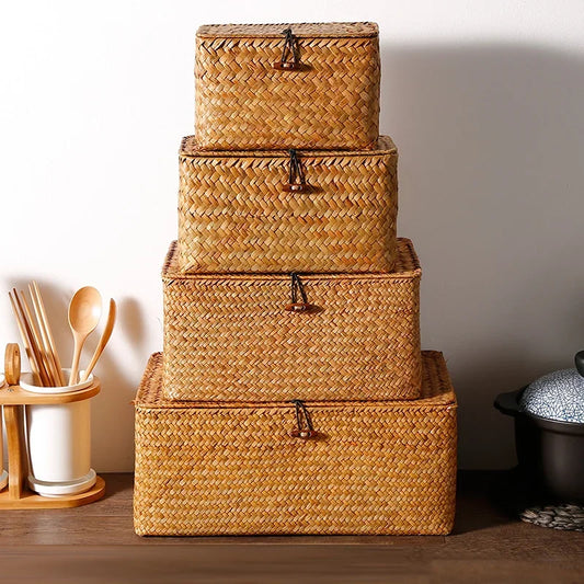 Stack of woven storage baskets on a wooden surface with kitchen utensils in the background.