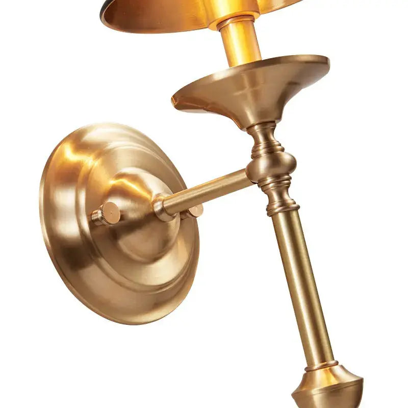 Gold wall sconce on a white background