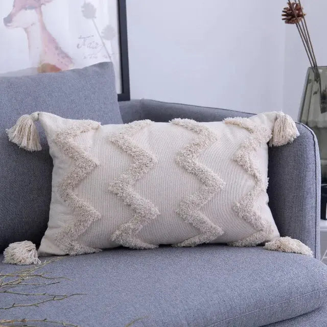 Decorative pillow with tassels on a gray sofa